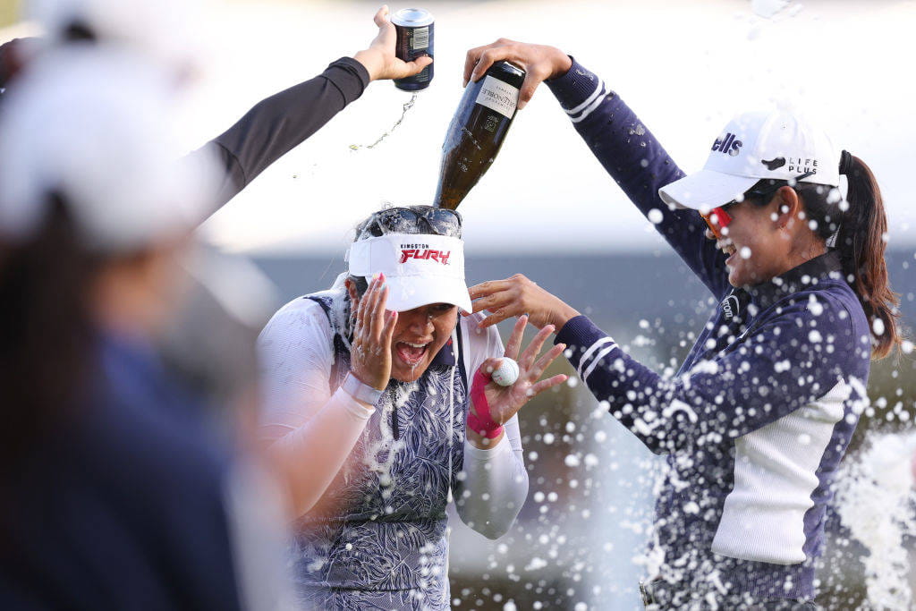 Lilia Vu is soaked in champagne after winning the AIG Women